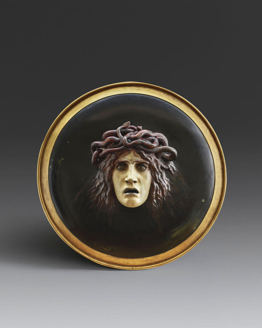 Arnold Böcklin (1827-1901)Shield with the Head of MedusaPolychrome plaster and papier-mâchéDiameter: 60.5 cmConceived in 1885 and modelled around 1887