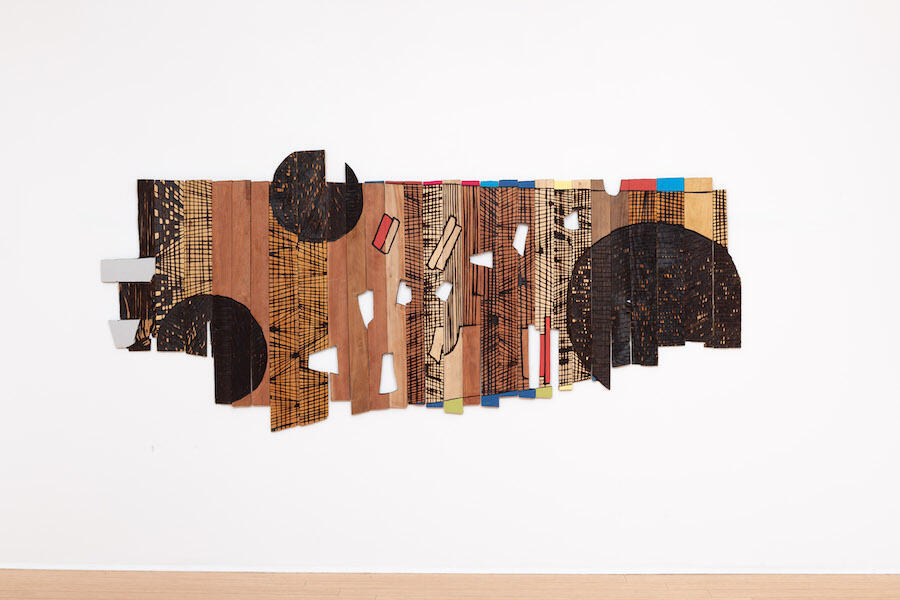 El Anatsui, Moon Fragments, 2024. Tropical hardwood and tempera, 1.5 × 3.4 m. Courtesy the Artist and October Gallery. © El Anatsui. Photo: Jonathan Greet