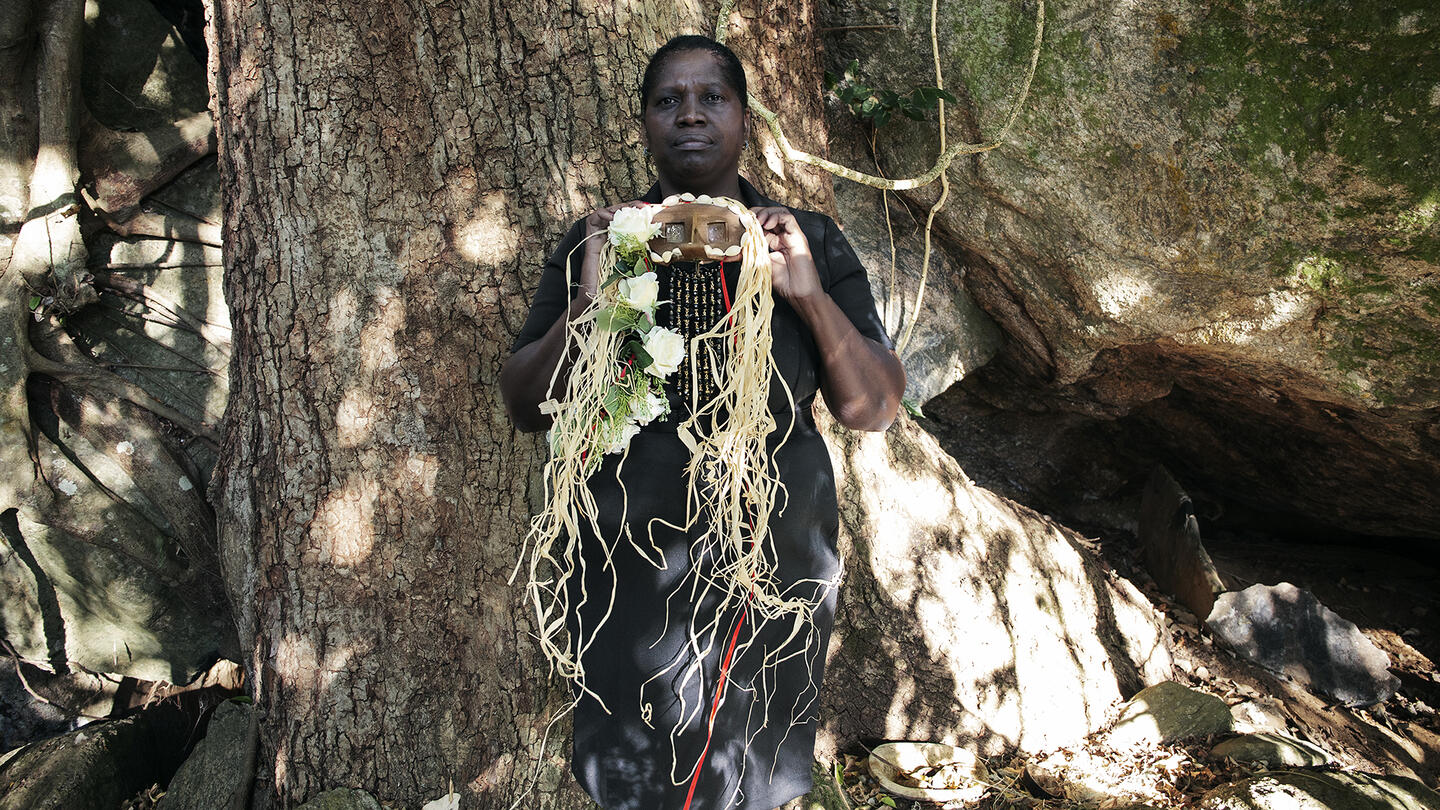 portrait of a Black woman holding a mask