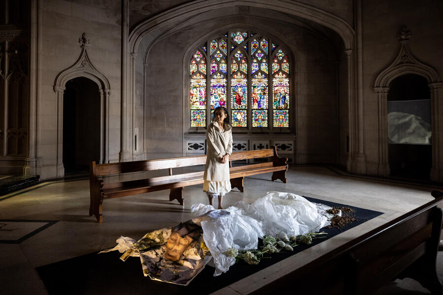 An installation view of a church with sculptures in it