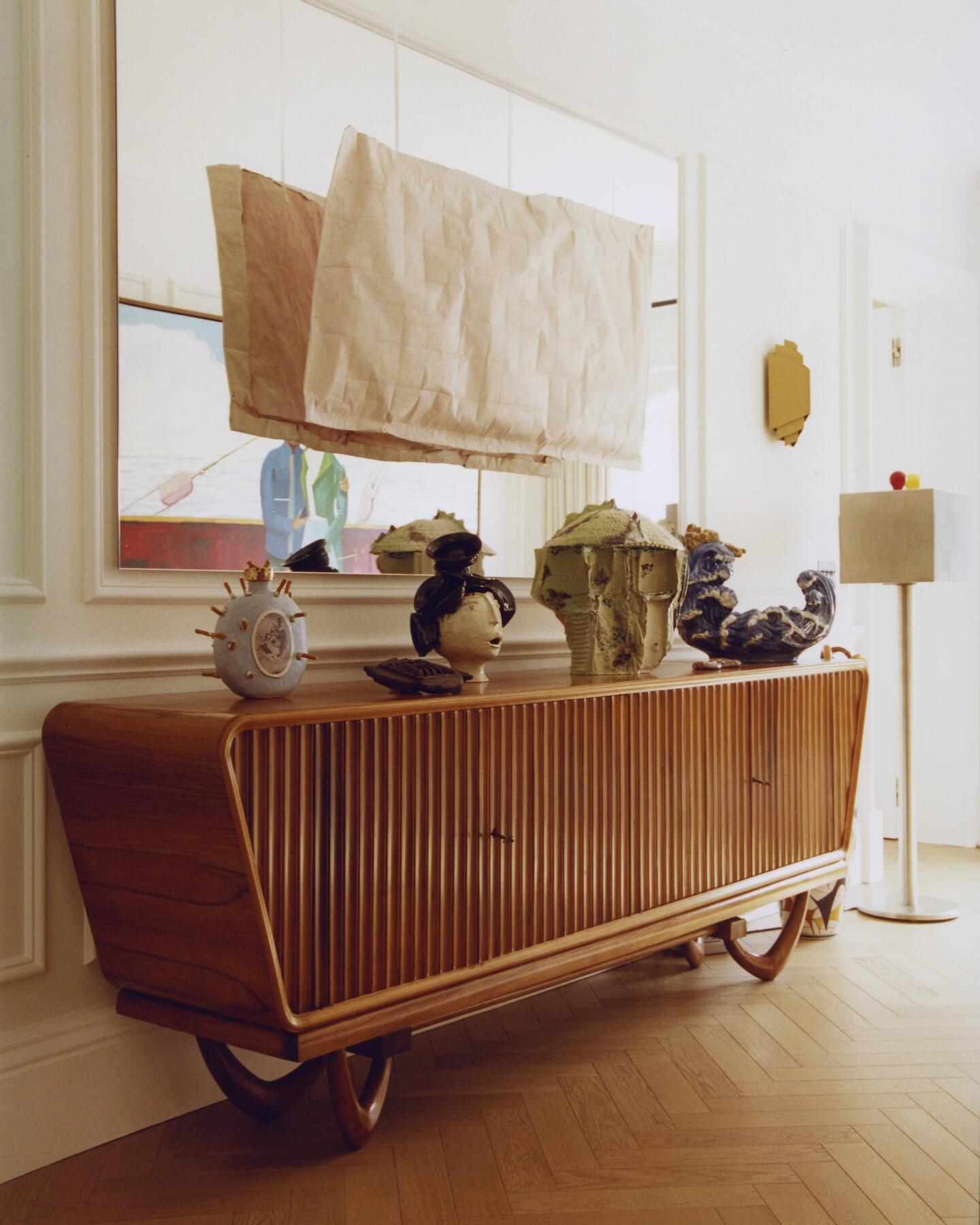 On wall: Easy to Mean Karla Black 2016 Sugar paper, cushion stuffing, oil paint, body 70 x 133 x 9cm  far back: Lawrence Abu Hamdan The Witness-Machine Complex 2021 Video installation, single steel stand equipped with light bulbs, projector and audio device 140 x 35 x 35 cm  On credenza l-r: You HAG! Lindsey Mendrick 2024 Glazed ceramic 27 x 24 x 16 cm  Elsa Rebelo 2024 Ceramics  Skins, Green (1 Basket, 1 Teddy Bear, 4 Vases, 1 Can, 1 Doily, 1 Highligther, 2 Ribbons, 1 Zipper, Cardboard) CFGNY 2024 Glazed porcelain 45 x 37 x 41 cm   Sermao aos Peixes/Sermon to the Fishes Antonio Carlos Auad 2013 Earthenware, hand painted complements 40 x 33 x 50cm