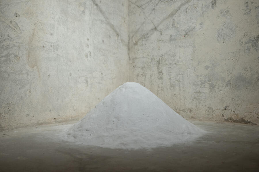 A large mound of salt in a gritty room